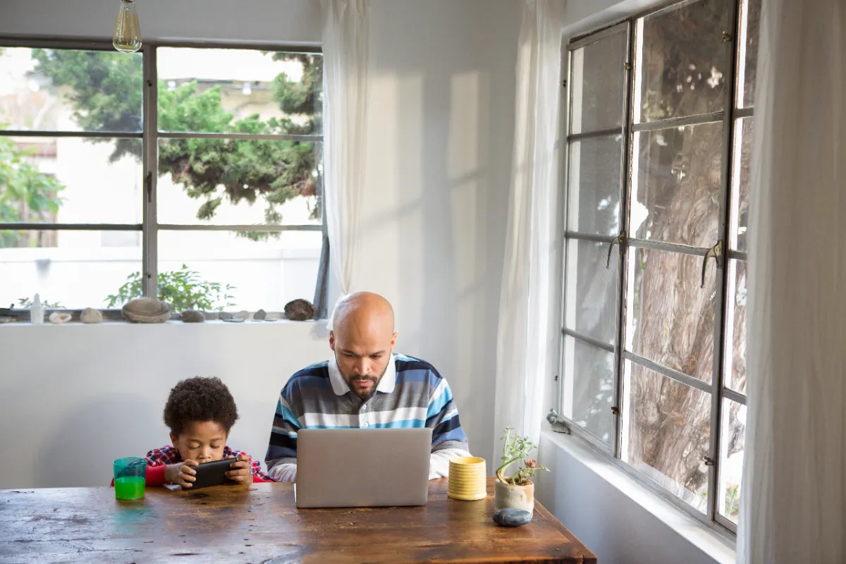 Father and son on devices.